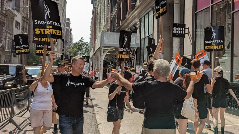 Actors union members holding strike signs on a New York sidewalk in 2023