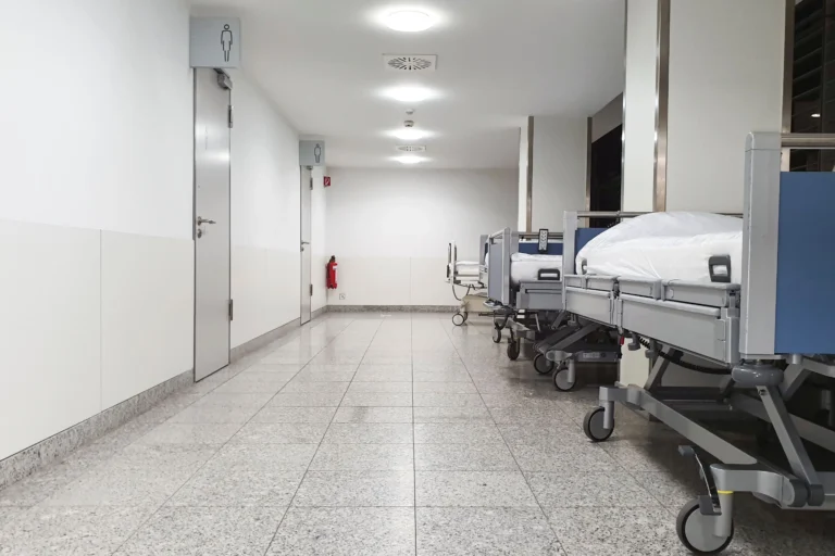 Empty hospital beds line a corridor in an illustrative file photograph