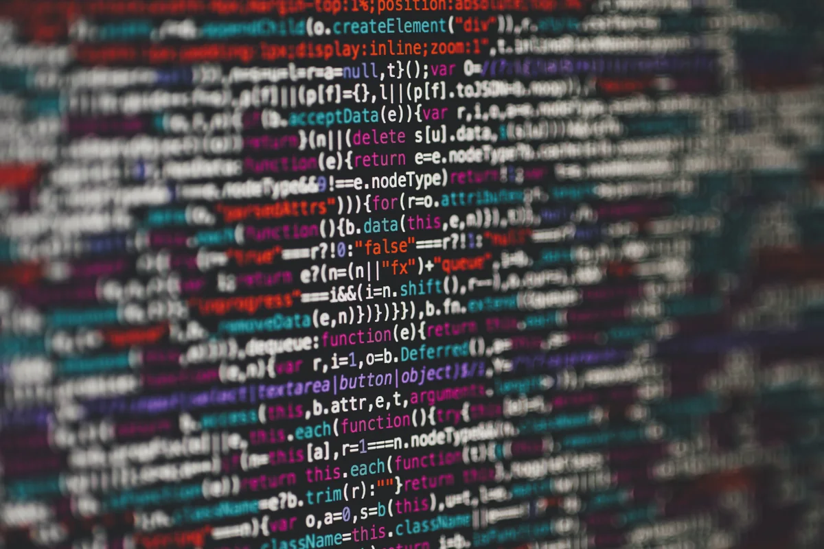 Colored source code on a dark screen with shallow focus