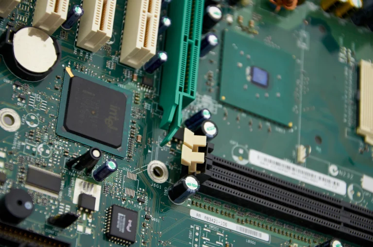 Chips, expansion slots and connectors on a green computer motherboard