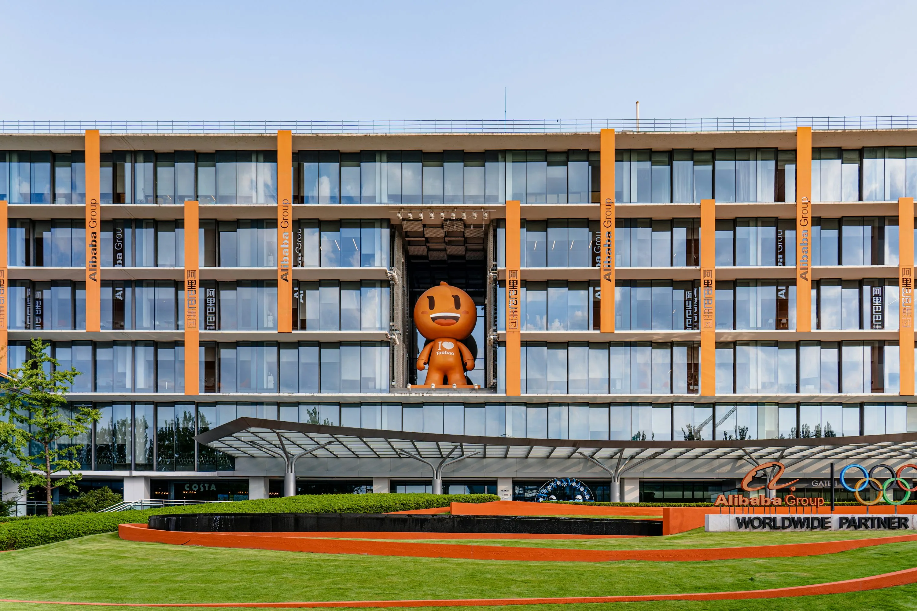 Alibaba headquarters in Hangzhou with glass windows and orange columns
