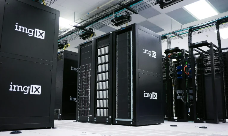 Rows of black server racks with imgix logos in a data center