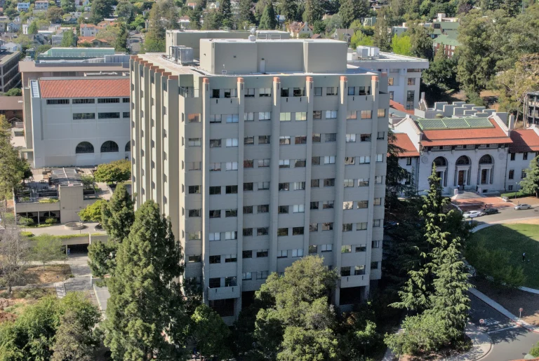 Evans Hall surrounded by campus buildings and trees at UC Berkeley, viewed from Sather Tower
