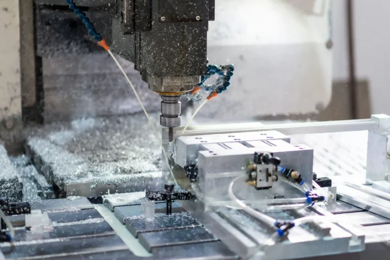 CNC milling tool cutting aluminum while coolant sprays across a metal workpiece