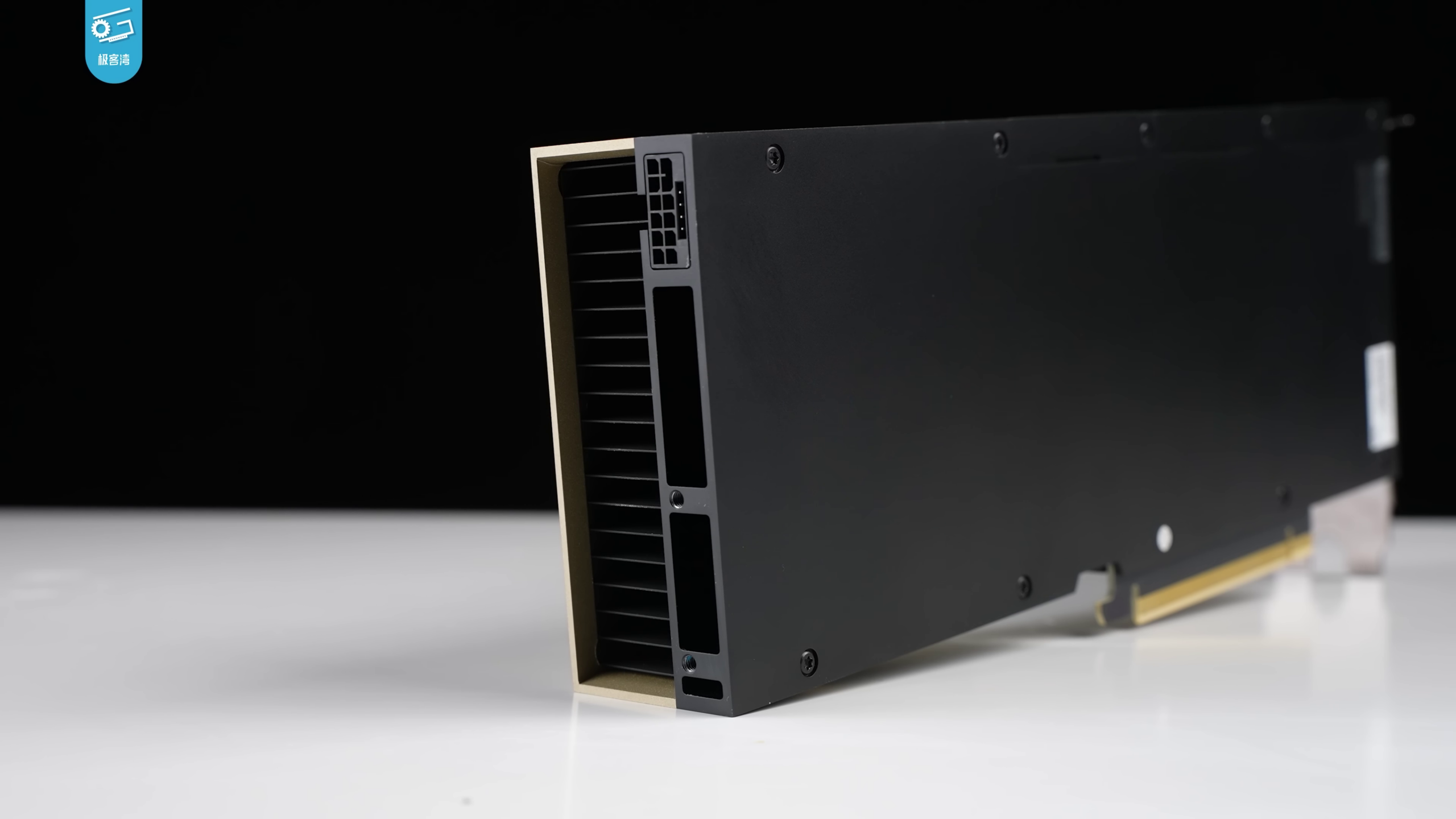 Rear view of an NVIDIA H100 accelerator on a white surface with the Geekerwan watermark in the upper left