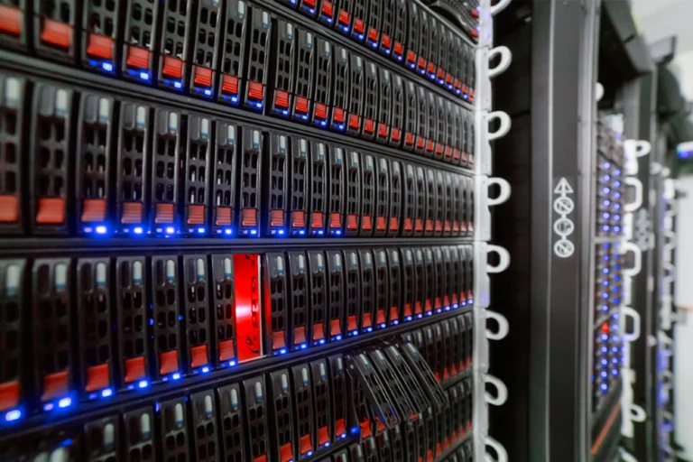 Rows of server drive bays with red latches and blue indicator lights