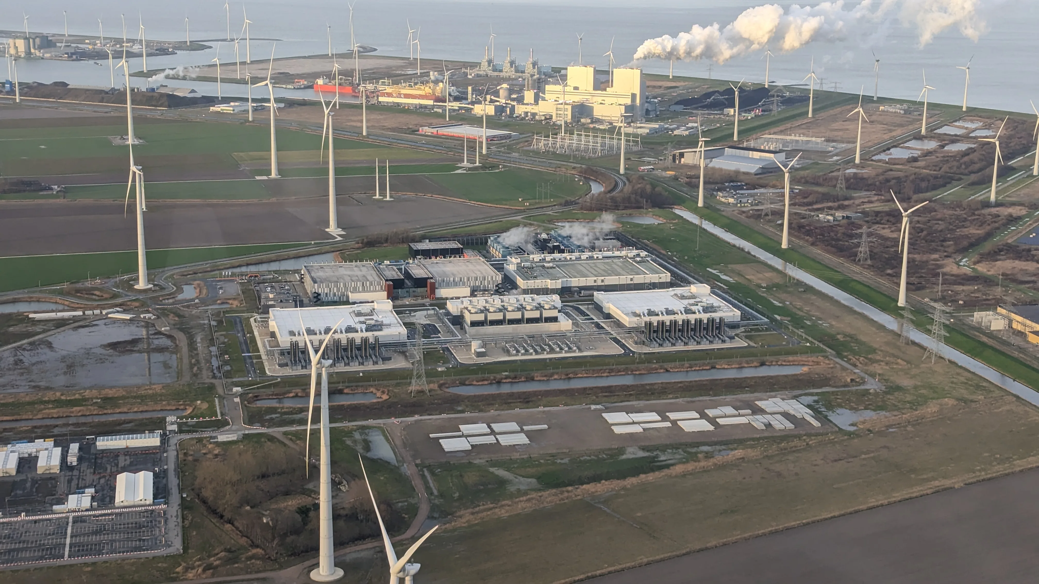 Aerial view of Google’s Eemshaven data center in the Netherlands with surrounding wind turbines.