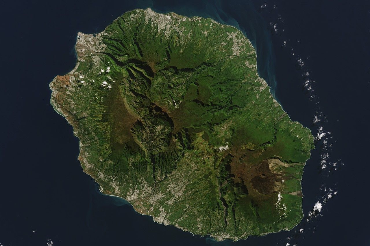 Landsat view of Réunion showing green volcanic terrain surrounded by dark ocean
