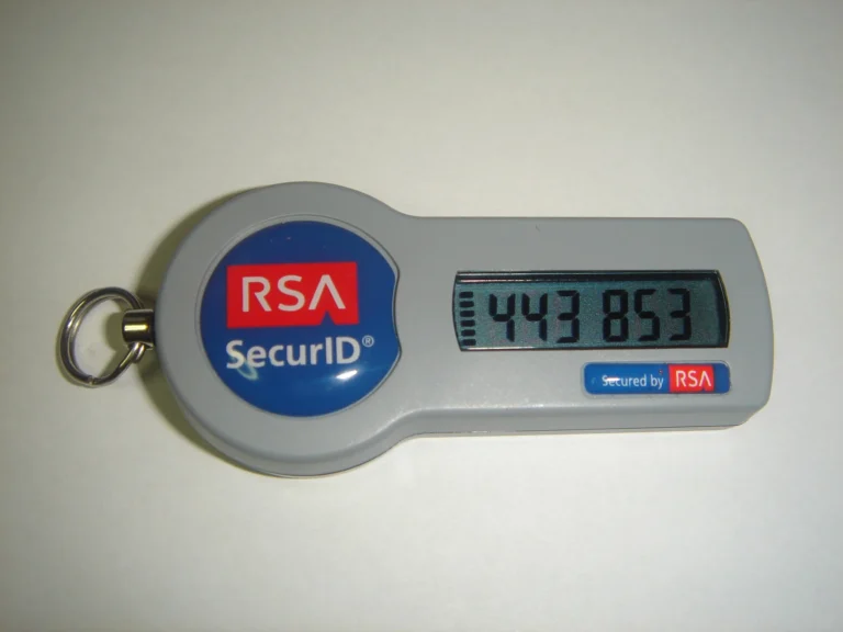 Gray RSA SecurID hardware token with a digital display on a light surface