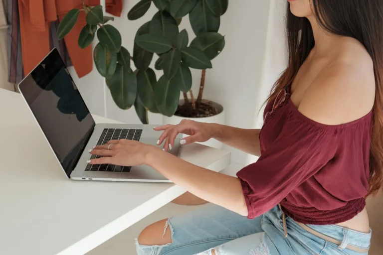 A retail shop owner checking online orders on a laptop