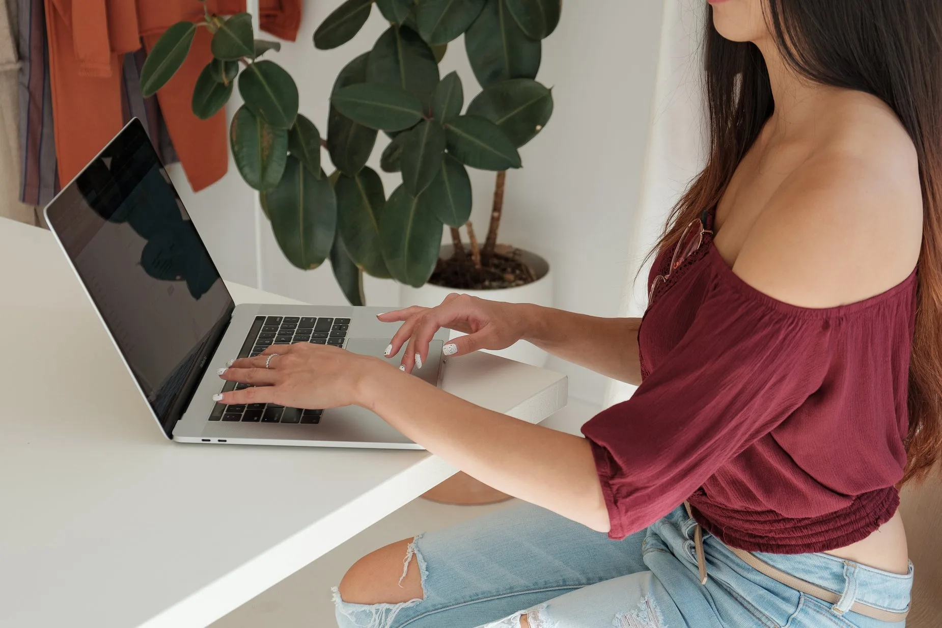A retail shop owner checking online orders on a laptop