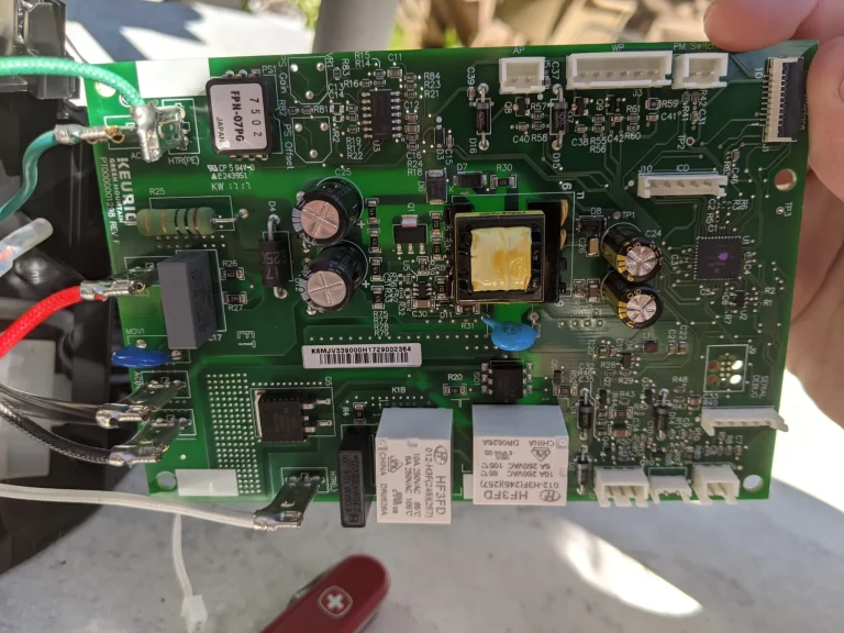 Green circuit board with electronic components and attached wires