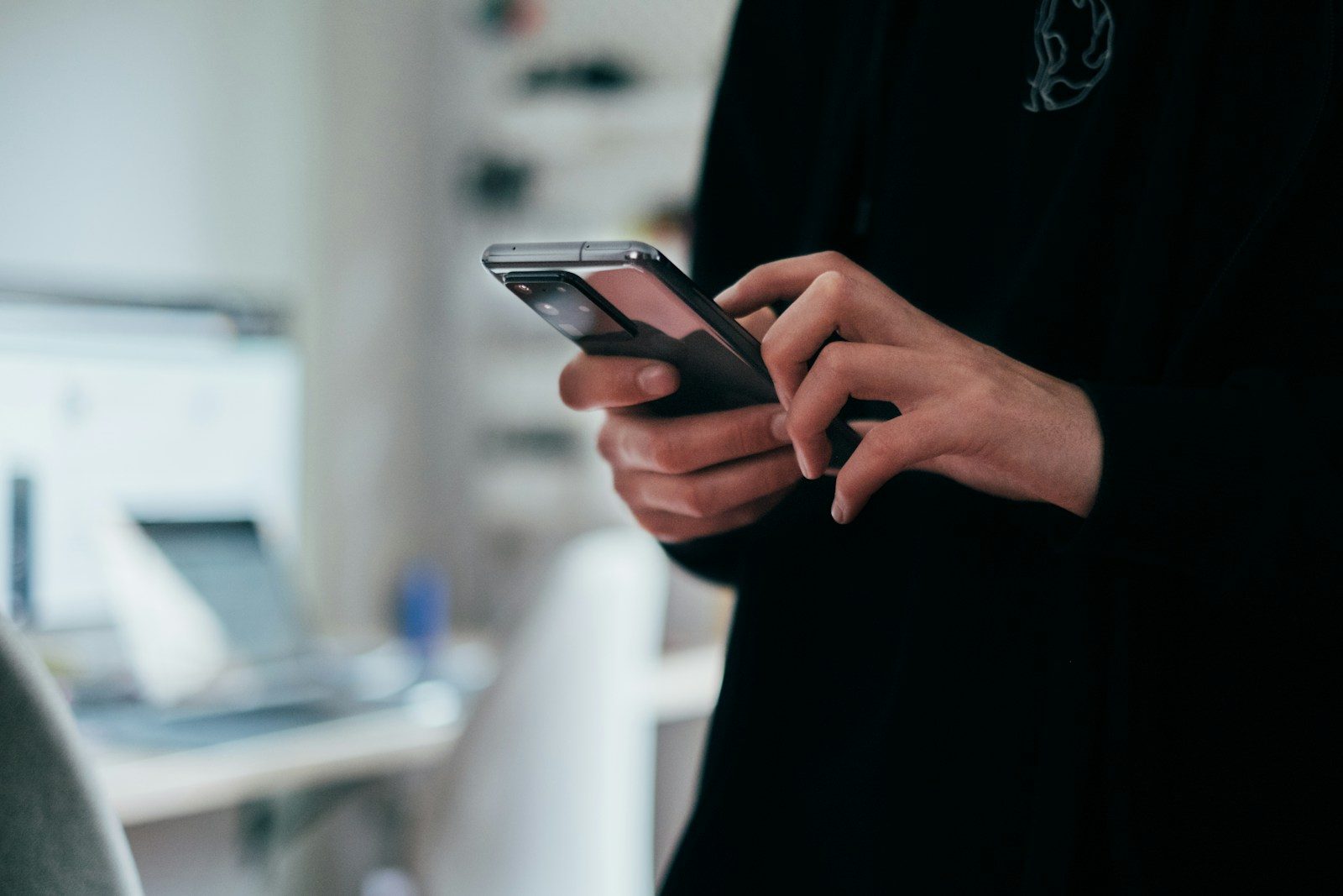 Hands holding a black Samsung Android smartphone