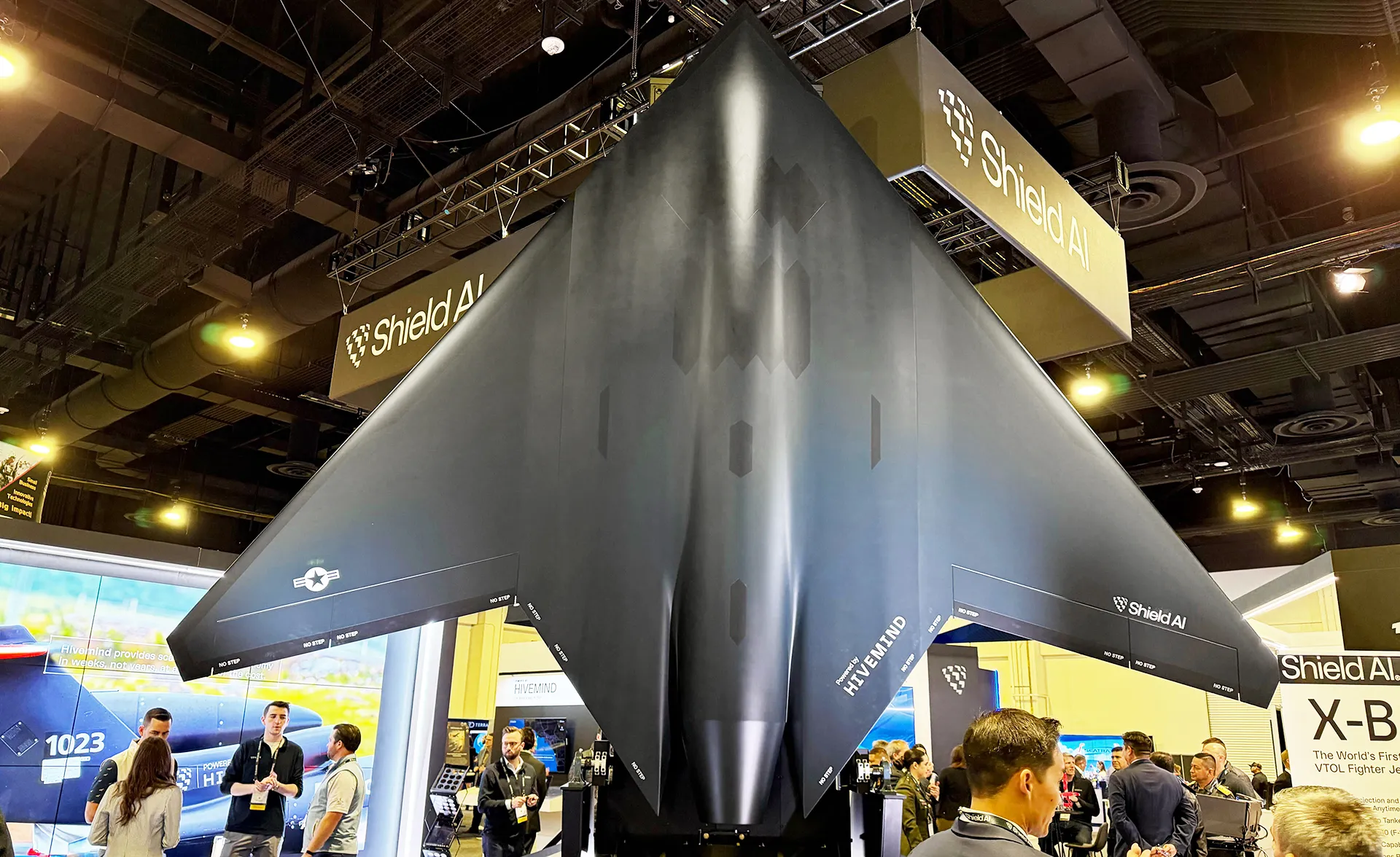 An X BAT display model above visitors at the Shield AI booth at Eurosatory 2026